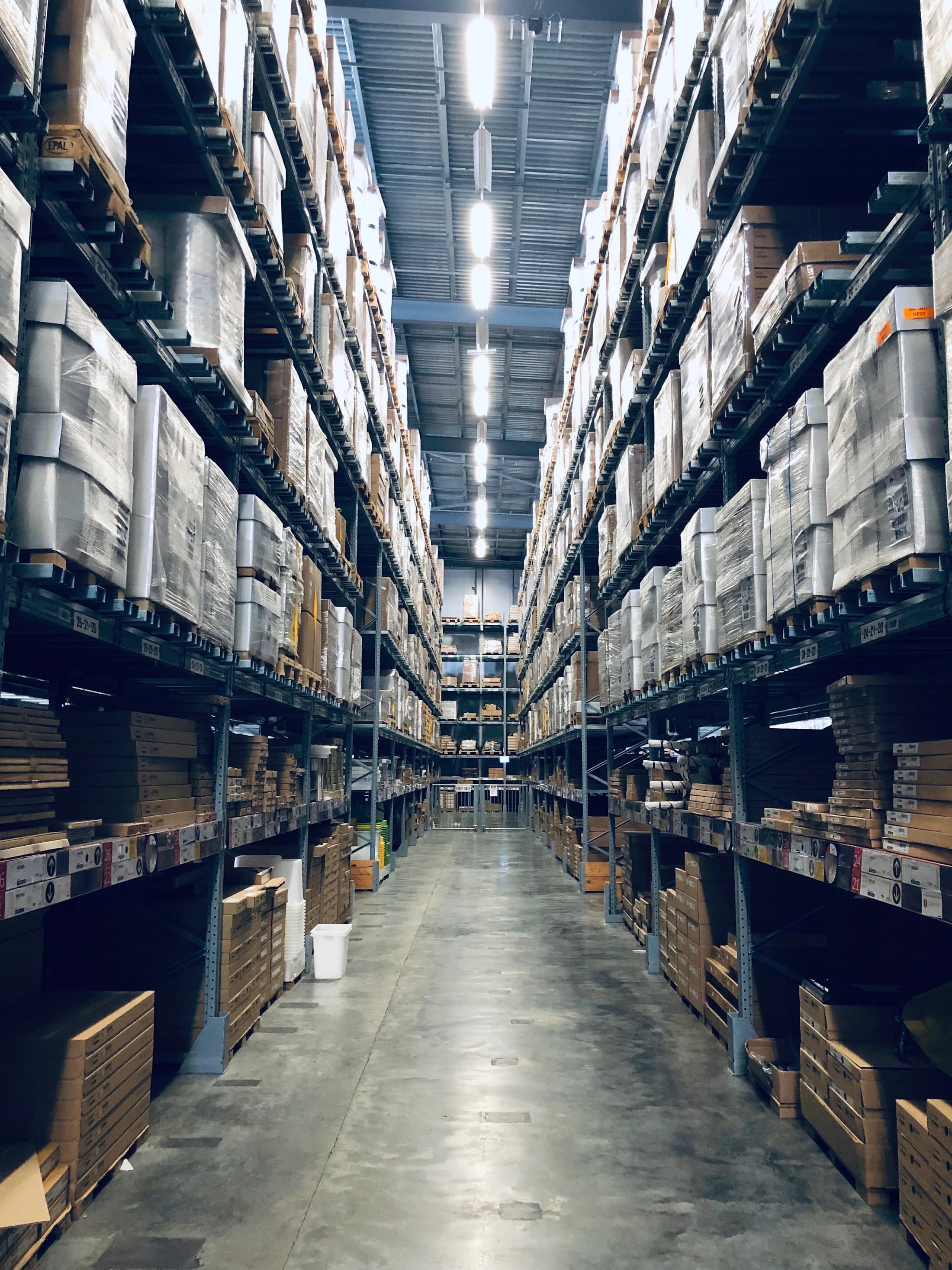 Wide aisle in an organised warehouse illustrating storage and supply operations